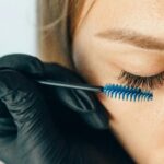 A-professional-applying-eyelash-extensions-using-a-blue-applicator-brush-for-a-refined-look.-2025-05-14T060348.917-0400-pexels-photo-5128267