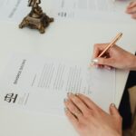 Close-up-of-hands-signing-a-divorce-decree-document-on-a-desk-showcasing-legal-process.-2025-05-22T075625.077-0400-pexels-photo-7876053