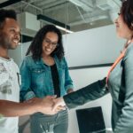 Smiling-couple-shaking-hands-with-advisor-in-modern-office.-2025-05-08T095355.843-0400-pexels-photo-7979605