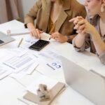 Two-professionals-collaborating-on-financial-documents-in-a-modern-office-setting.-2025-05-22T134333.402-0400-pexels-photo-6779716