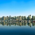 Vancouver-skyline-with-a-serene-marina-reflection-under-a-clear-blue-sky.-2025-06-28T053403.988-0400-pexels-photo-11123494