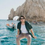 Man-sitting-on-a-boat-with-a-scenic-view-of-El-Arco-Cabo-San-Lucas-in-the-background.-2025-09-28T060428.504-0400-pexels-photo-34045090