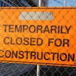 New Brunswick's Lifeline: A Crucial Guide to the AIP Letter of Support for Work Permit Extensions Orange-sign-behind-fence-reading-Temporarily-Closed-for-Construction-at-site.-2025-10-25T060446.765-0400-pexels-photo-209717